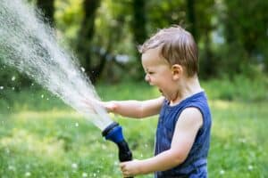 kid watering moringa