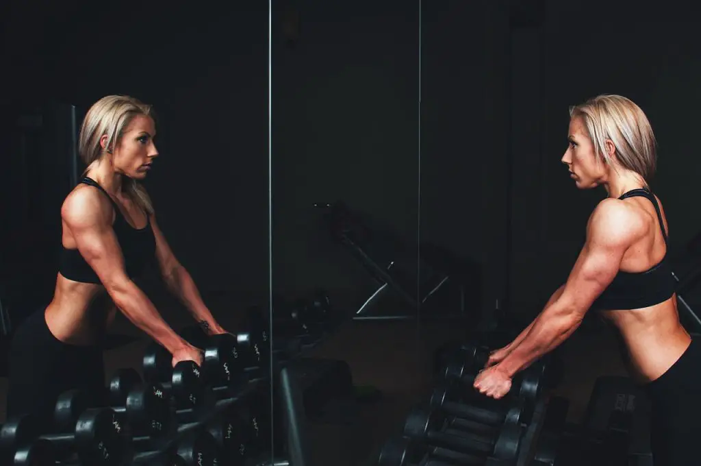 Woman with muscles working out at the gym