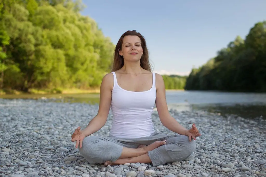 Woman meditating and showing signs of hormone balance